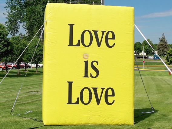 Inflatable Cheerios box that says 'Love is Love'