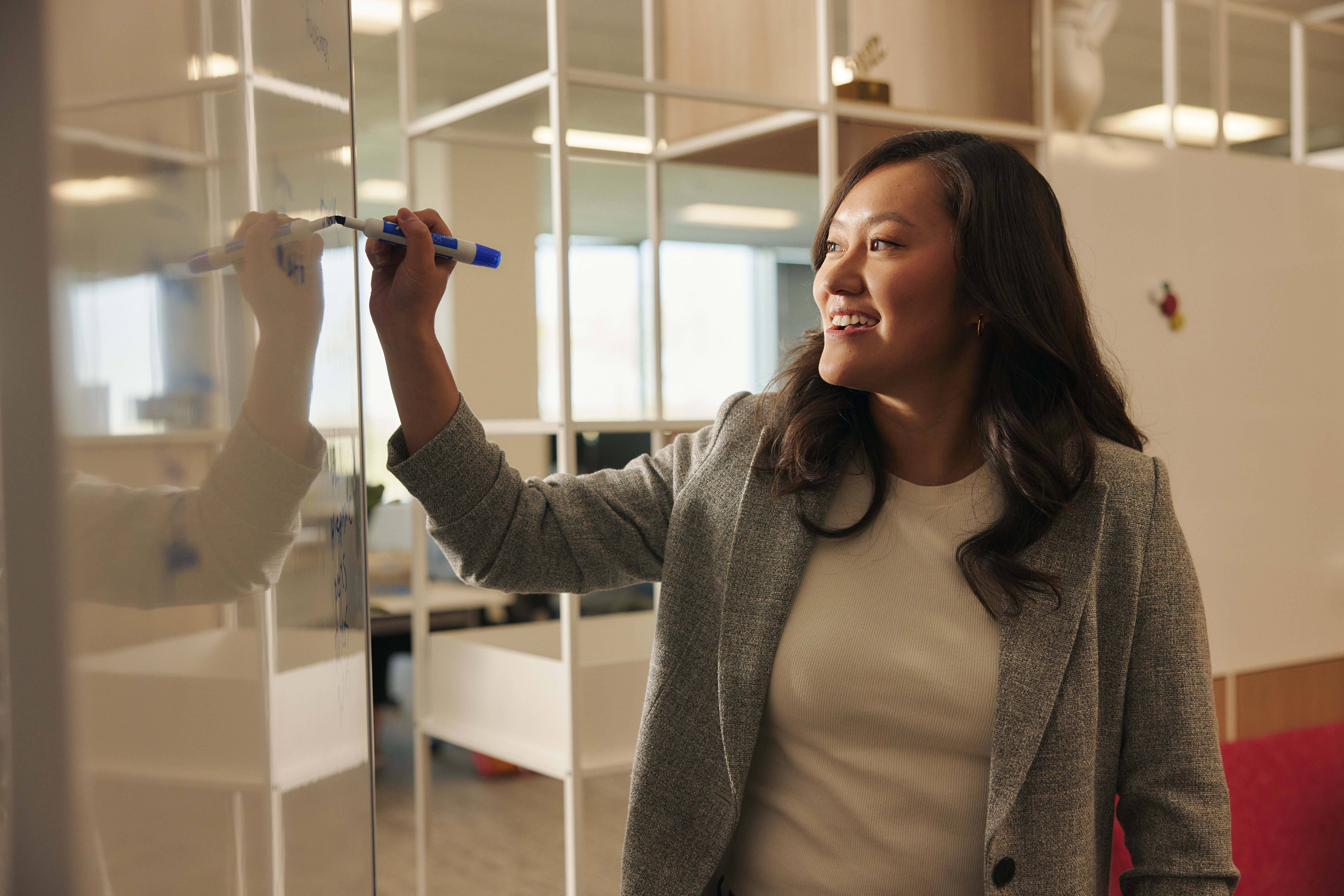 Woman writing on whiteboard